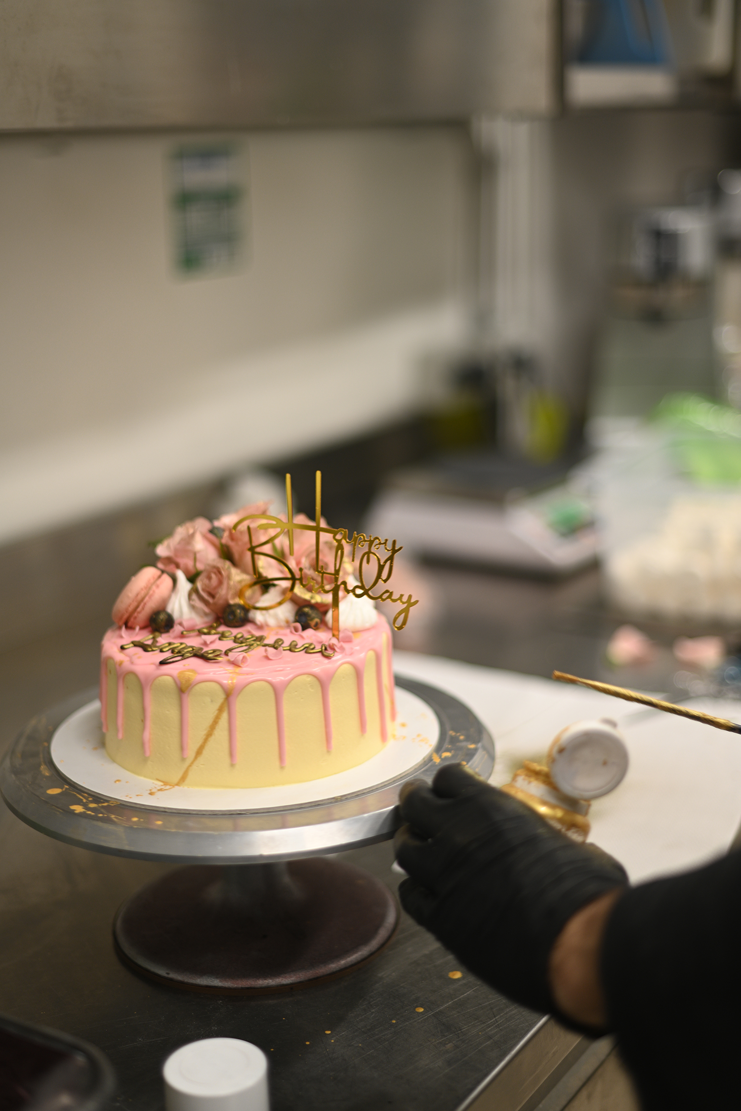 fresh frosted icing dripping pink vanilla birthday cake real roses and macaron decoration on top